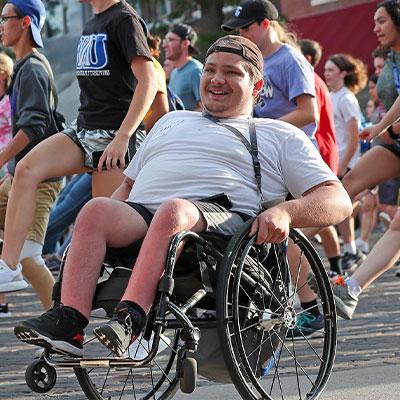 a student in a wheelchair participates in a student parade